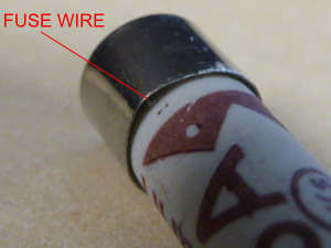 Fuse wire trapped on end cap
