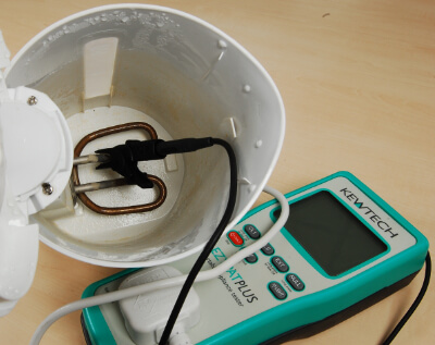 attaching the test lead to a kettle