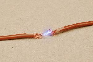 Electric arc between damaged wires 