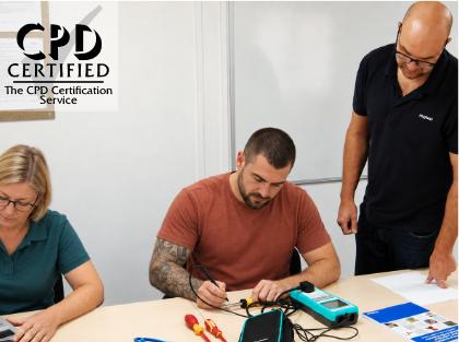 Delegates practising PAT testing with an instructor during a CPD-accredited onsite training course